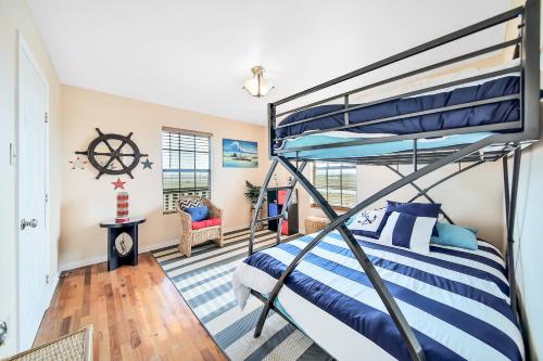 a bedroom with a bunk bed with blue and white sheets at Escape Bay Views Large Deck Group Ready in Port Bolivar