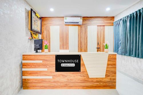 a room with a desk with a sign on it at Townhouse Bangalore Kundalahalli Metro Station in Bengaluru