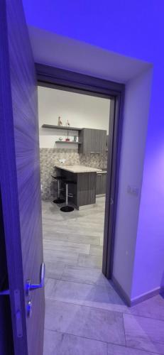a door leading to a living room with a table at Costantinopoli Suite in Giovinazzo