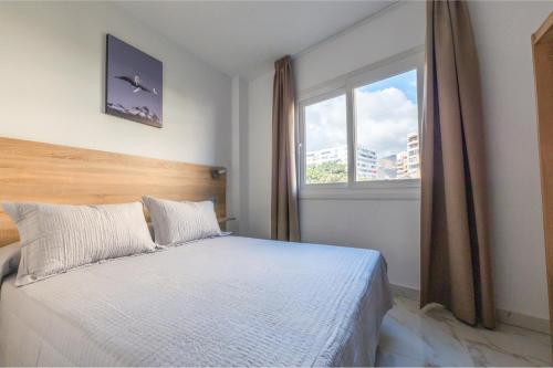 a bedroom with a bed and a window at Hotel Nogalera in Torremolinos
