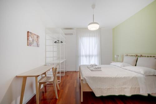 a white bedroom with a bed and a desk at Casa Diletta— Bright Spaces, Warm Moments in Stazione Bari Centrale