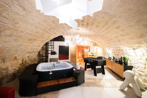 a bathroom with a bath tub in a stone wall at Dimora San Rocco in Molfetta