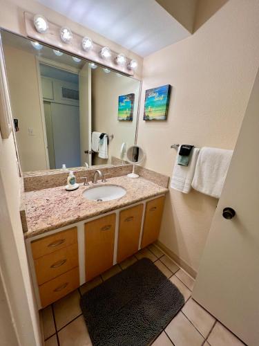 a bathroom with a sink and a large mirror at Lahaina Shores #316 in Lahaina