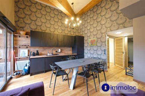 a kitchen with a table and chairs in a room at Apartment in Auron in Auron