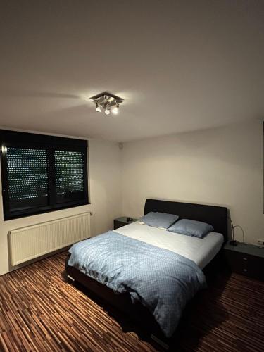 a bedroom with a bed and a window at Villa Bukvic in Zavidovići