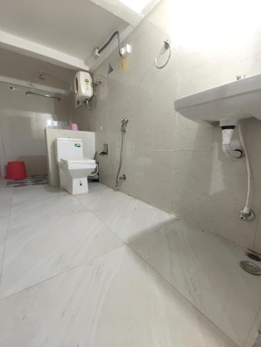 a bathroom with a sink and a toilet at Saagar's Farmstay in Jalpāiguri