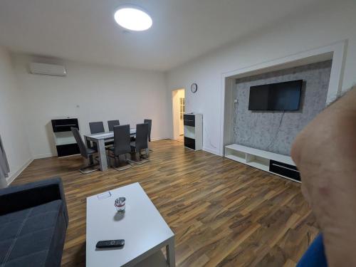 a living room with a couch and a tv on a wall at Voll eingerichtete Wohnung in Geilenkirchen in Geilenkirchen