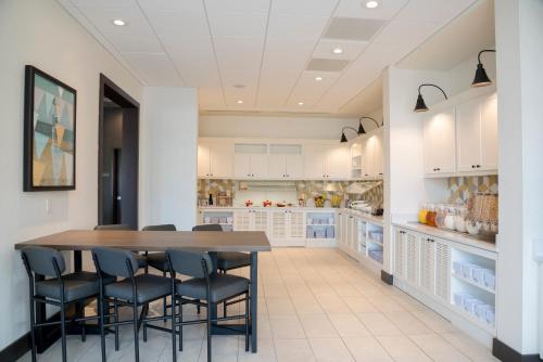 a large kitchen with a table and chairs at Hyatt Place Sarasota/Lakewood Ranch in Sarasota
