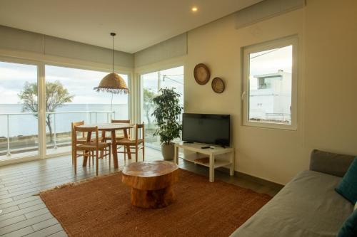 a living room with a couch and a table with a coffee table sidx sidx sidx at Bay House in Ponta Delgada