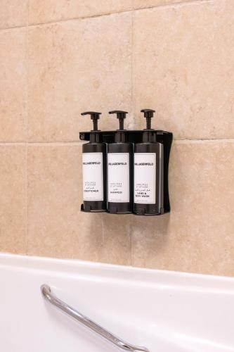 a soap dispenser on a wall above a bath tub at The Residences Towers - 3 Minute Walk to Dubai Fountain in Dubai