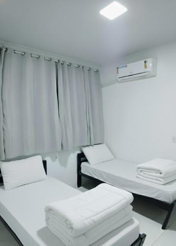 a hospital room with two beds and a window at Cop30 in Belém