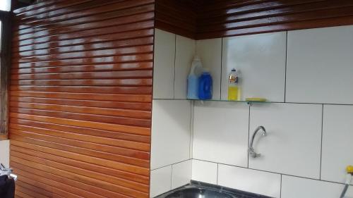 a kitchen with a sink and a wooden wall at Cop30 in Belém
