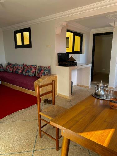 a living room with a couch and a table at Seaview apartment in Mirleft