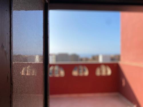 a view from a window with a view of a building at Seaview apartment in Mirleft