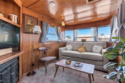 a living room with a couch and a tv at Spartan Royal Mansion in Tombstone