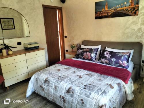 a bedroom with a bed and a bridge on the wall at L'angolo di Erika in Biella