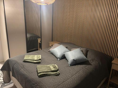 a bedroom with a bed with two towels on it at Apartment for five near Railway station in Rovaniemi