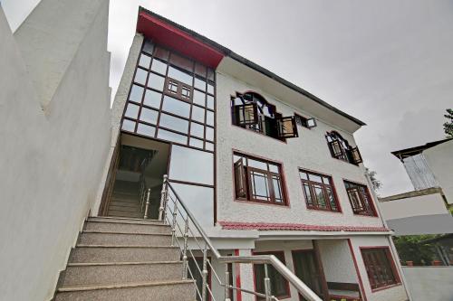 a building with stairs leading up to the entrance at Hotel O Hameed in Durgjan