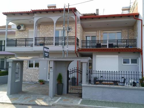 a apartment building with a balcony and a gate at Polys Apartment and Paraskevi studio with view in Ptolemaida