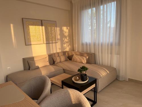 a living room with a couch and a table at Golden Gaia Villas in Kipía