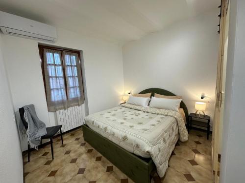 een slaapkamer met een bed en een raam bij La casa di Carlotta in Loano