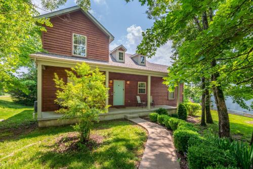 a brown house with a pathway in front of it at Hickory Hideaway with Communal Pool Access in Hollister