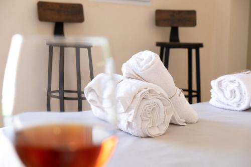 a towel on a table next to a glass of tea at BIANCA LAMIA Ostuni in Ostuni