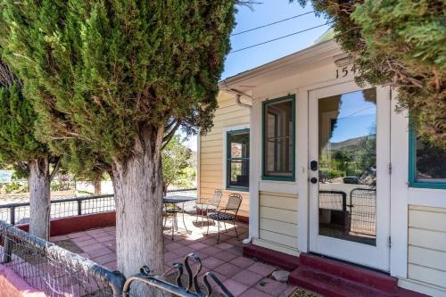 a house with a patio and a tree at Copper Queen Retreat in Bisbee
