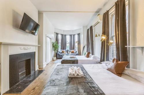 a living room with two beds and a fireplace at New Studio in Center City that Sleeps 4 with Fast Wifi in Philadelphia