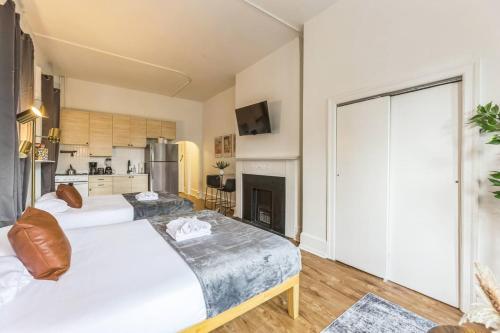 a large bedroom with two beds and a kitchen at New Studio in Center City that Sleeps 4 with Fast Wifi in Philadelphia