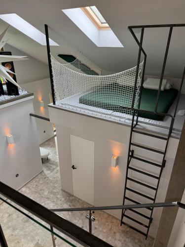a loft conversion of a house with a spiral staircase at Foundation - Waldhaus mit Sauna & Hottub in Zittau