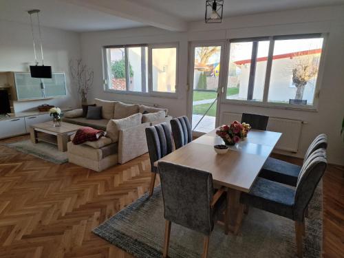 a living room with a table and a couch at Seasons apartmani in Osijek
