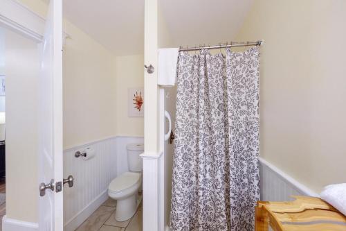 a bathroom with a toilet and a shower curtain at The View III at Sheepscot River in Fort Edgecomb