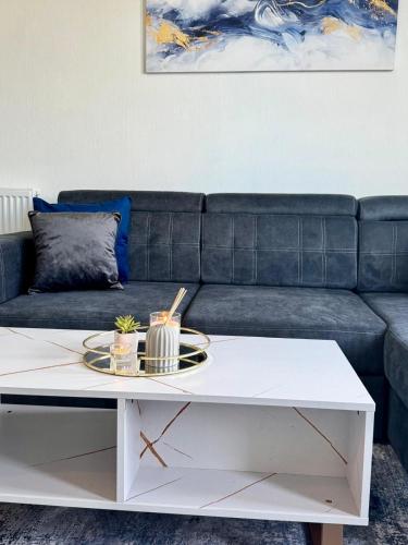 a living room with a couch and a white coffee table at Comfort in the East in Glasgow