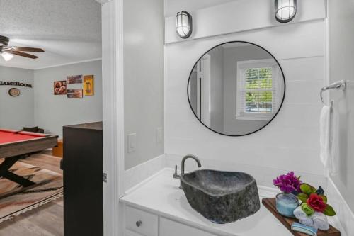 a bathroom with a sink and a mirror at Lexington Leisure House- 4BR in Lexington