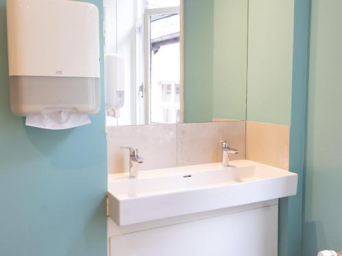 a bathroom with a sink and a mirror at St Christopher's Inn Bruges - The Bauhaus in Bruges