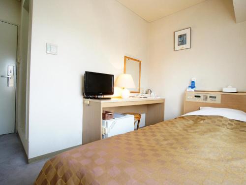 Postel nebo postele na pokoji v ubytování Hotel Trend Nagano