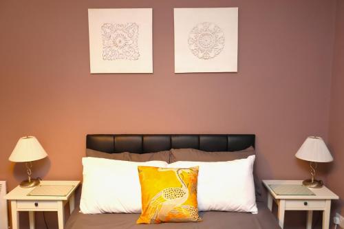 a bedroom with two lamps and a bed with two tables at The Savile - Luxury Apartment Leeds - Your Next Stay in Leeds