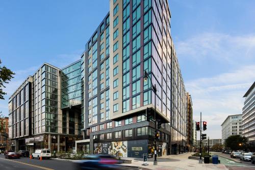 a tall building with glass windows on a city street at Bluebird Suites at Capitol Hill in Washington, D.C.