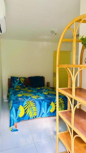 Résidence Oncle Sam في لو جوسيير: غرفة نوم بسرير وبطانية زرقاء وصفراء