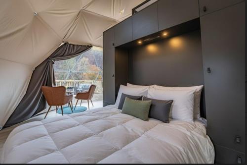 a large bed in a room with a tent at Once-in-a-Lifetime Escape Celestine Hot Tub Between Two State Parks in Pipestem