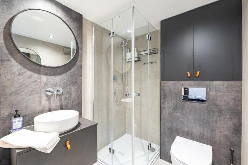 a bathroom with a shower and a toilet and a sink at Once-in-a-Lifetime Escape Celestine Hot Tub Between Two State Parks in Pipestem