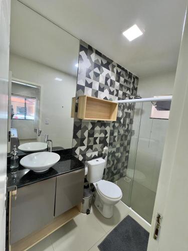 a bathroom with a toilet and a sink and a shower at Casabela - Summer Ville - Lençóis Maranhenses in Barreirinhas