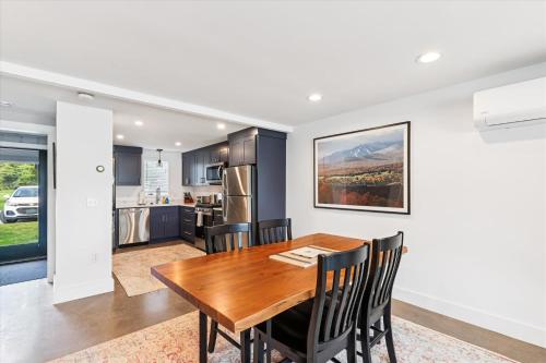a kitchen and dining room with a wooden table and chairs at Village Green 9F in Stowe