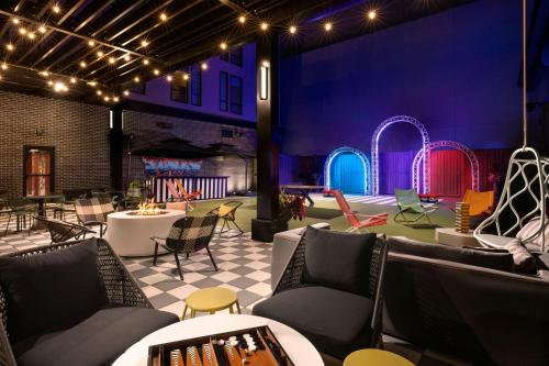 a room with couches and chairs and a playground at Moxy Allentown Downtown in Allentown