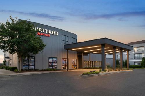 a building with a sign on the front of it at Courtyard Charlotte Airport North in Charlotte