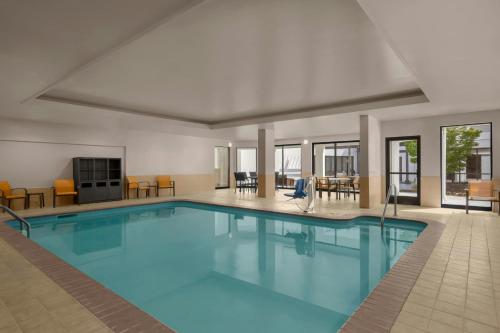 a large swimming pool in a hotel room at Courtyard Charlotte Airport North in Charlotte