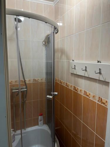 a bathroom with a shower and a tub and a toilet at Seven Hotel VIP in Korostenʼ