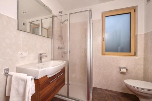 a bathroom with a sink and a shower at Landhaus Zell in Längenfeld