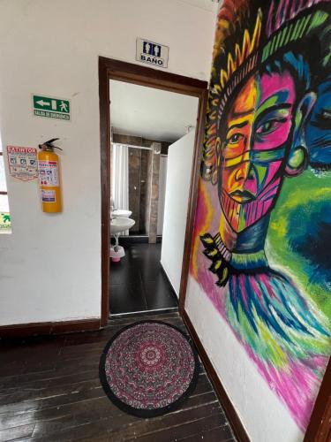 a painting on the wall of a hallway at Hostal CQ Chapinero in Bogotá